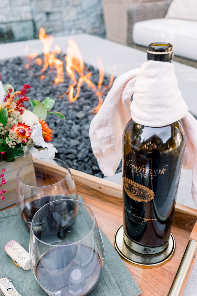 Firepit and tray with wine and flowers