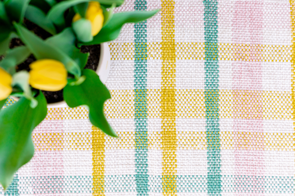 Plaid pastel mat and yellow tulips