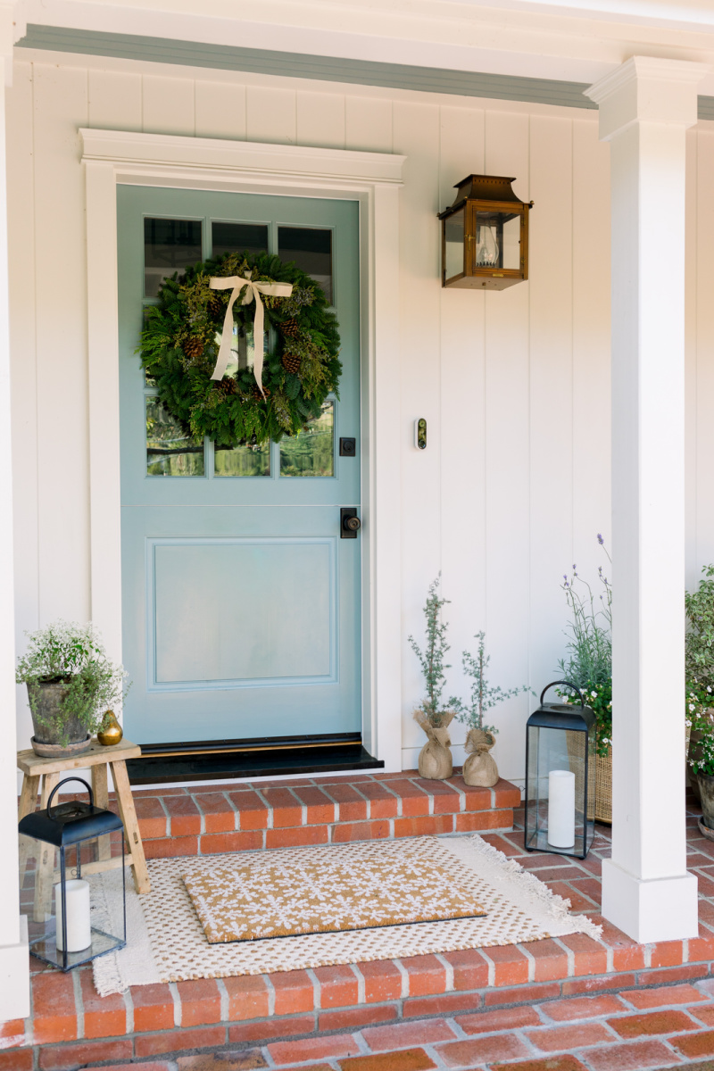 Blue Dutch Door with holiday wreath and lanterns