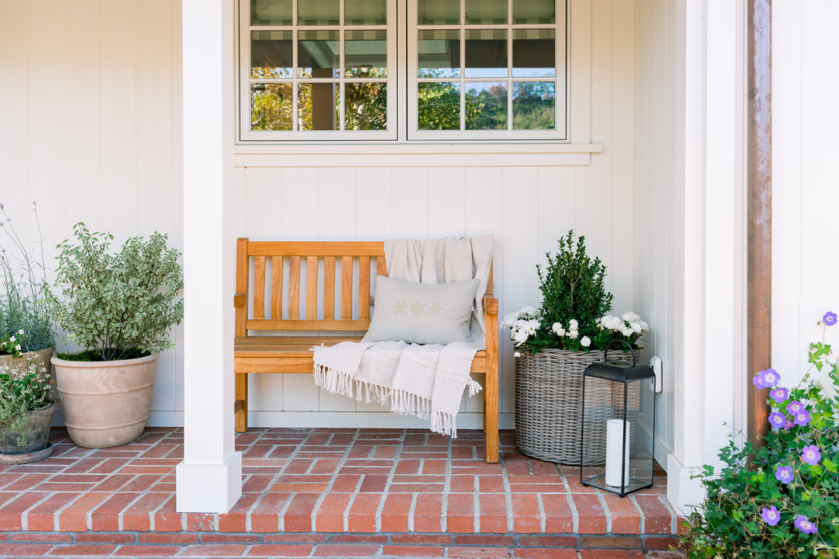 Teak porch bench with holiday decor