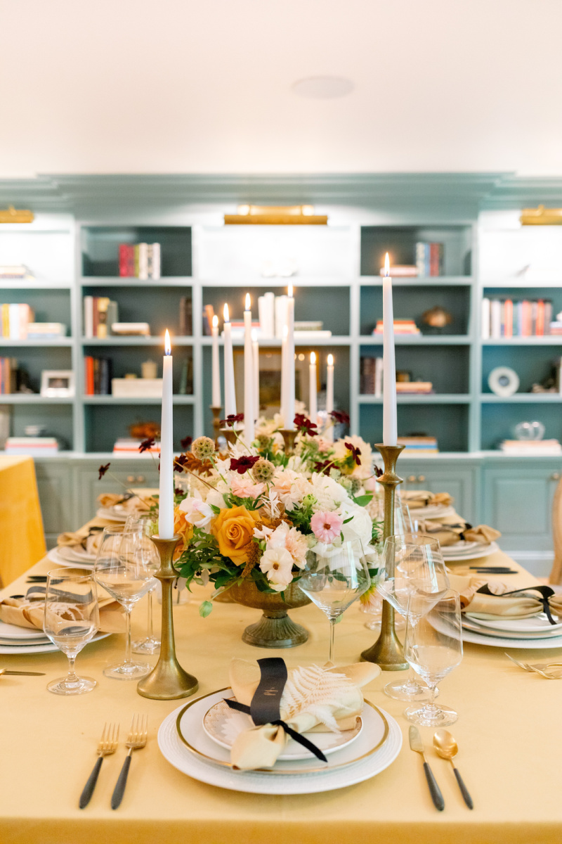 Dinner party table with gold table cloth and candlesticks