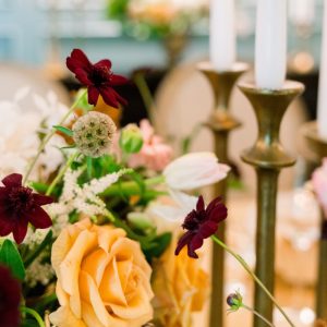 Brass candlesticks and autumnal flowers