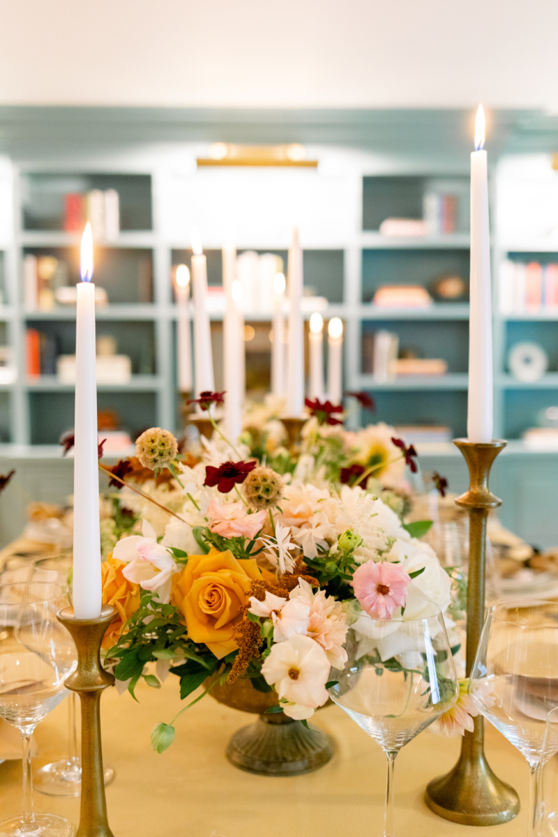 Dinner party table with gold table cloth and autumnal flowers