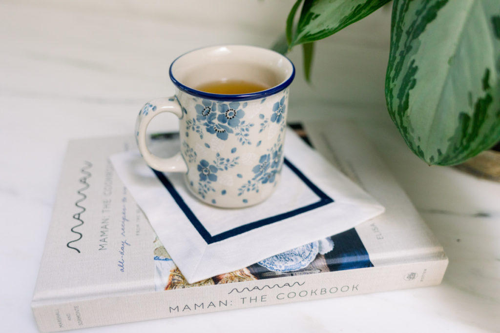 Maman Cookbook with Blue and White Mug on Top
