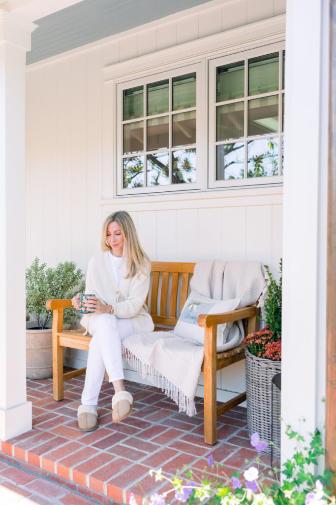 Woman on porch bench in slippers