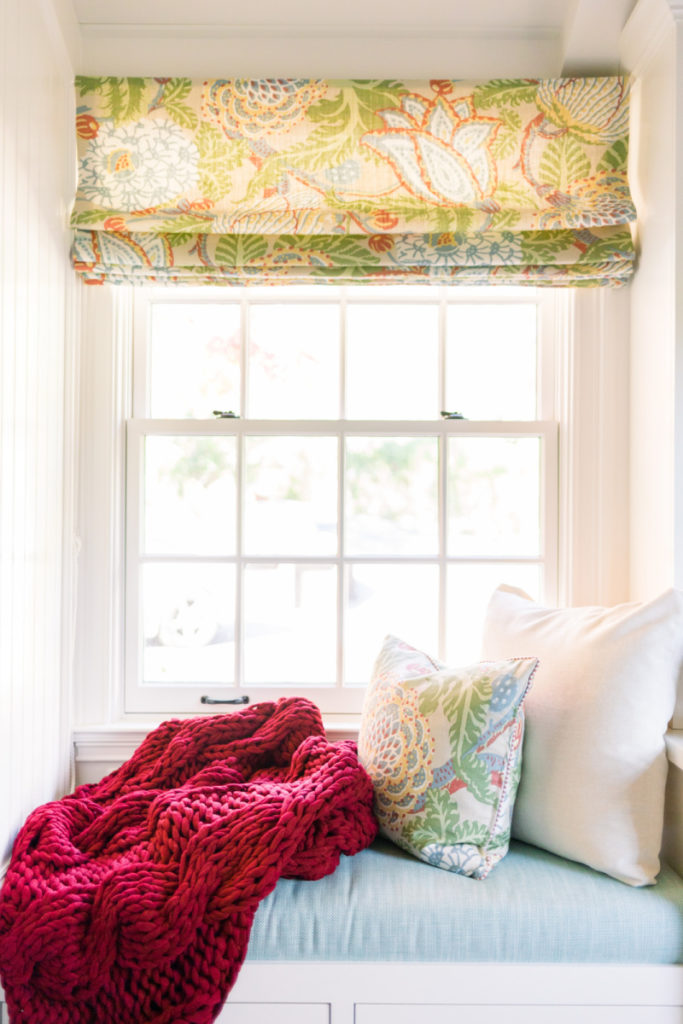 Window seat with cranberry throw blanket