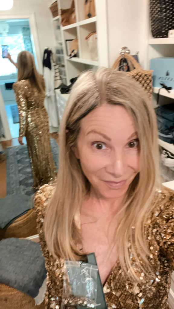 Woman trying on gold gown