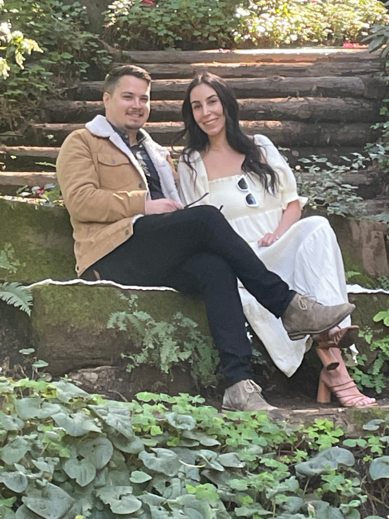 Couple sitting on bench in forrest