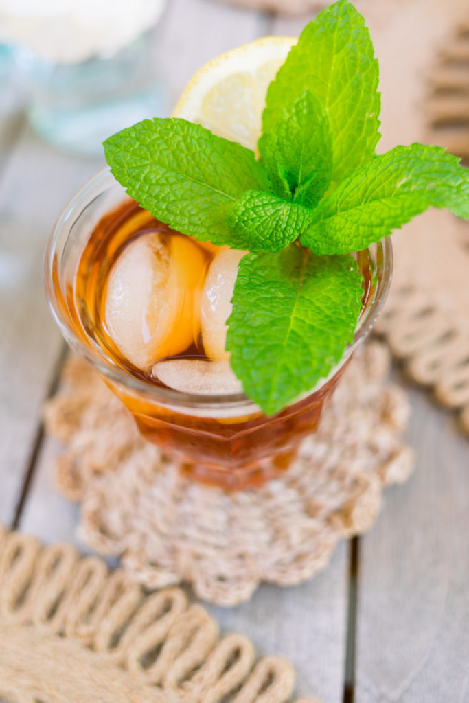 Glass of ice tea with lemon and mint