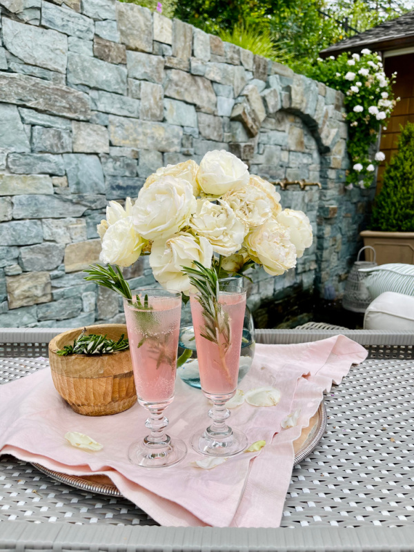Two spritzer glasses and rose bouquet