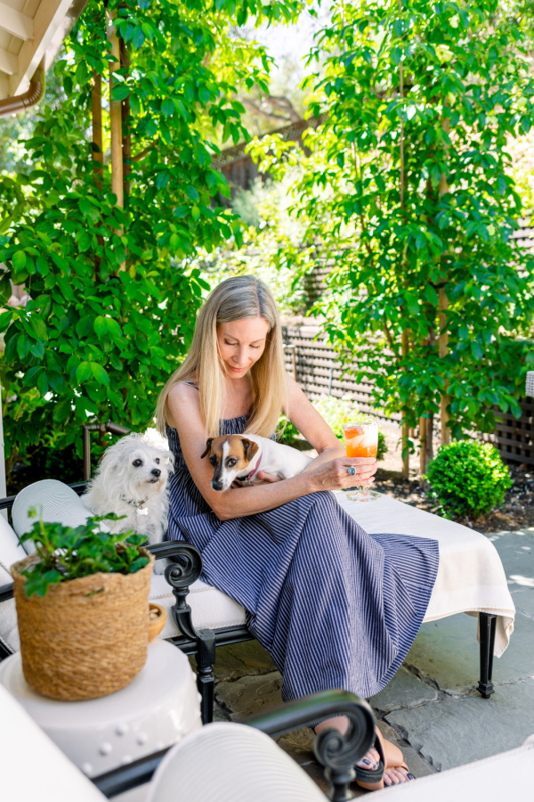 Woman and dogs on patio chaise