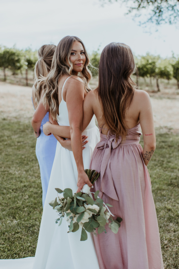 Bride and sisters at outdoor wedding