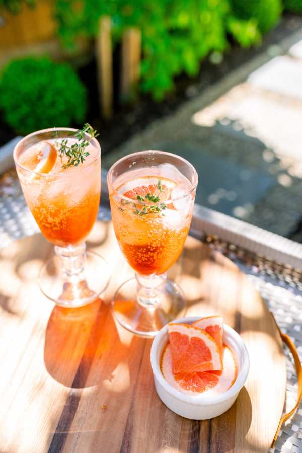 Grapefruit Aperol Spritz drink on tray in garden