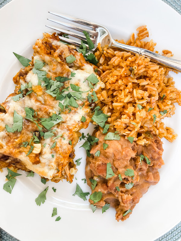 Chicken Enchiladas on plate with rice and beans