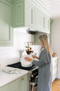 Woman staring pot on stove