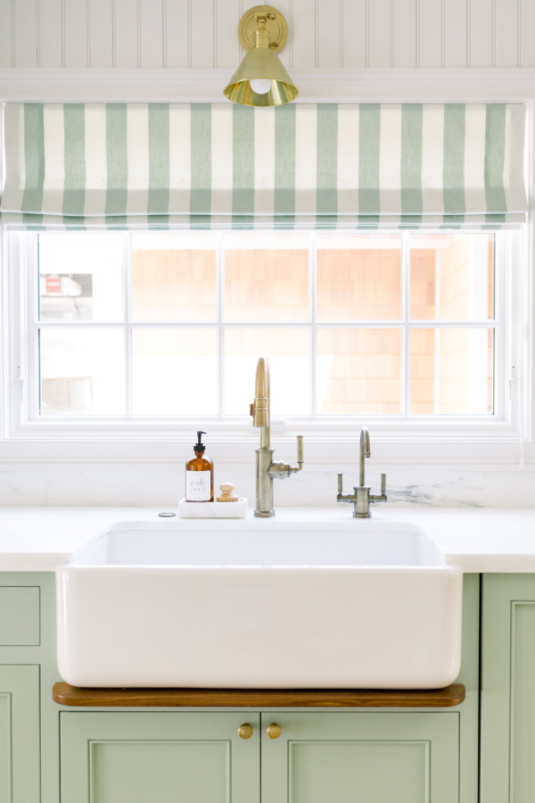 Kitchen sink with drip ledge, cabinets Farrow & Ball Vert de Terre.