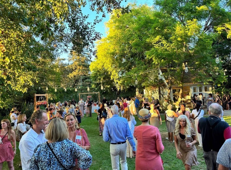 Guests mingling outdoors at A Home To Share book launch party.