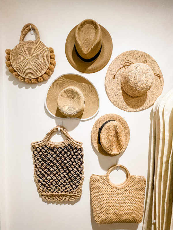 Hat and straw bag wall in closet.