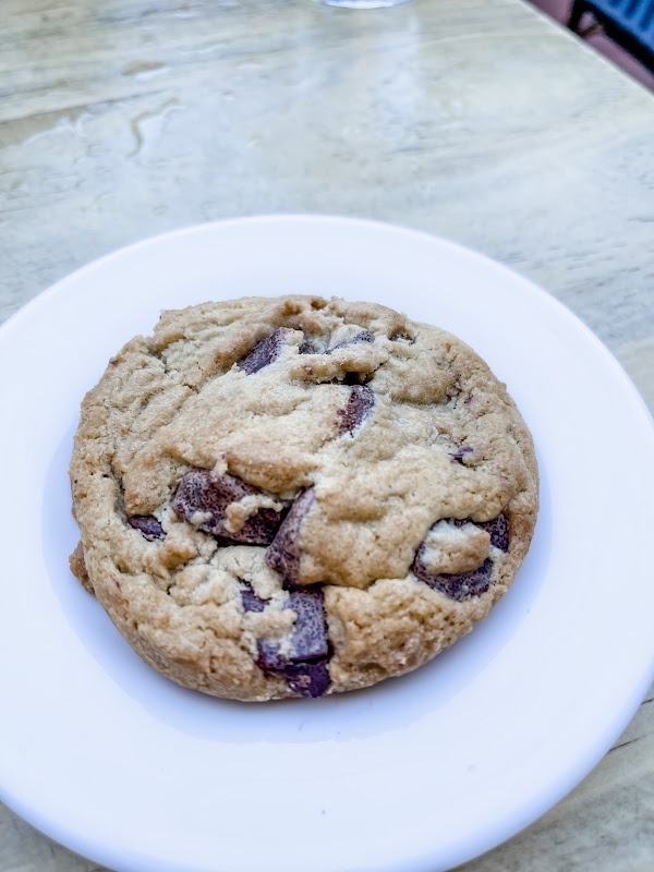 Large chocolate chip cookie on a plate.