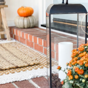 Fall front porch vignette with anthropology lanterns.