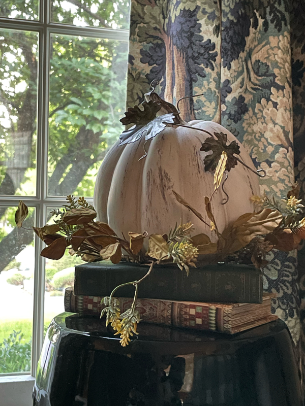 Pumpkin sitting on books in Erin Evolving home.