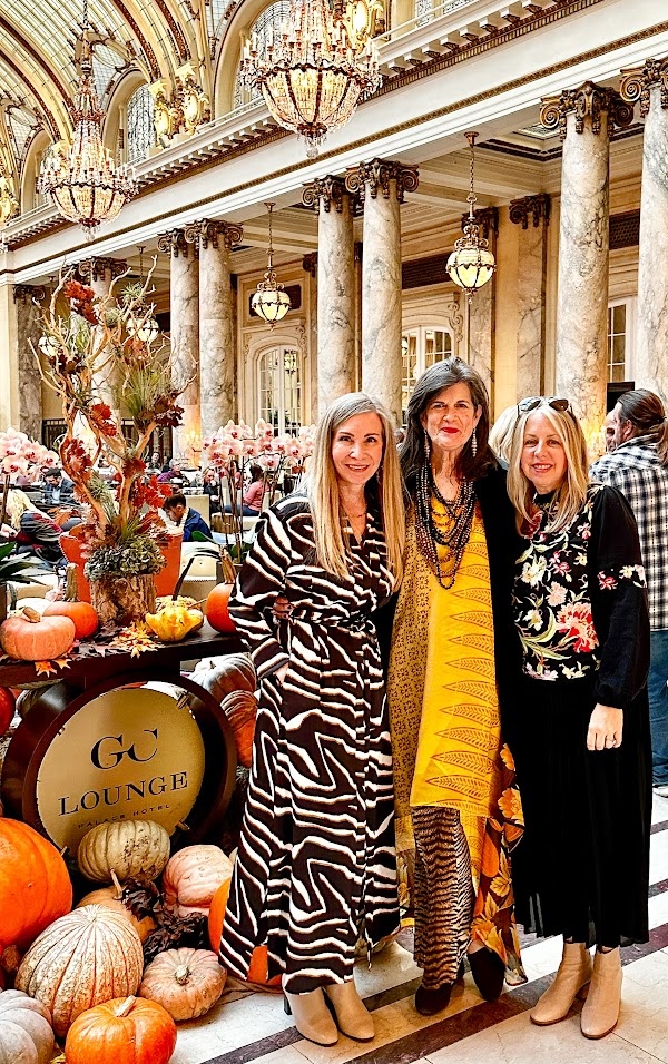 Three woman posing in front of pumpkin display at the Palace Hotel.
