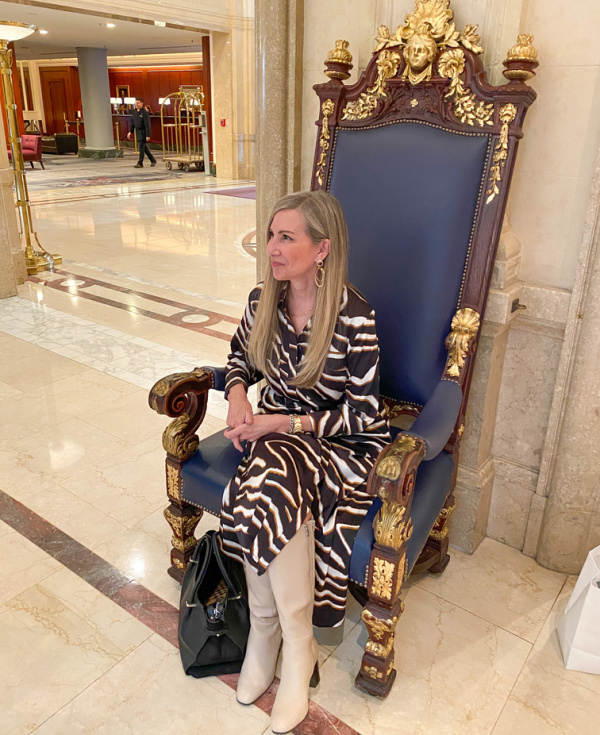 woman sitting on chair in hotel lobby.