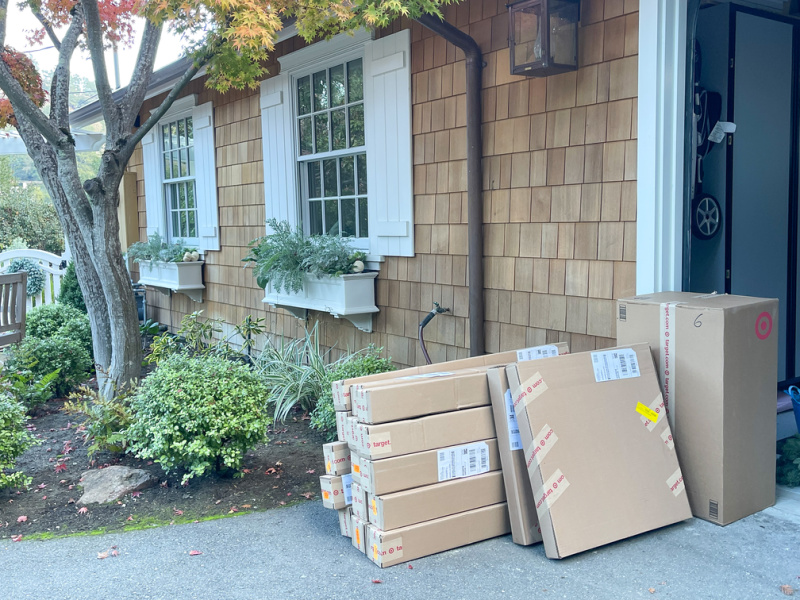Packages stacked outside driveway.