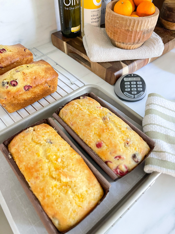 Cranberry Orange Bread Loaves cooling on counter.