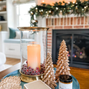Christmas coffee table vignette with mantle in background.