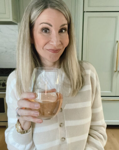Woman holding glass of rose wine.