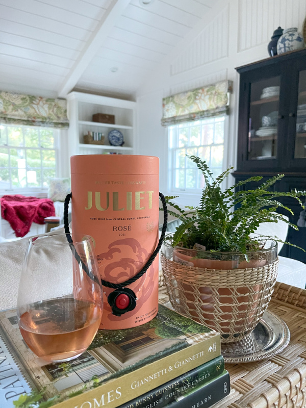Juliet Dry Rose wine in a box next to glass of wine and plant.