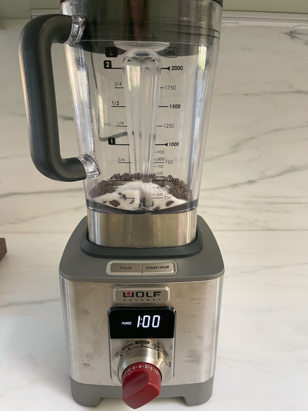 Blender filled with chocolate and sugar.