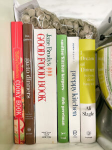 Stack of cookbooks on counter.