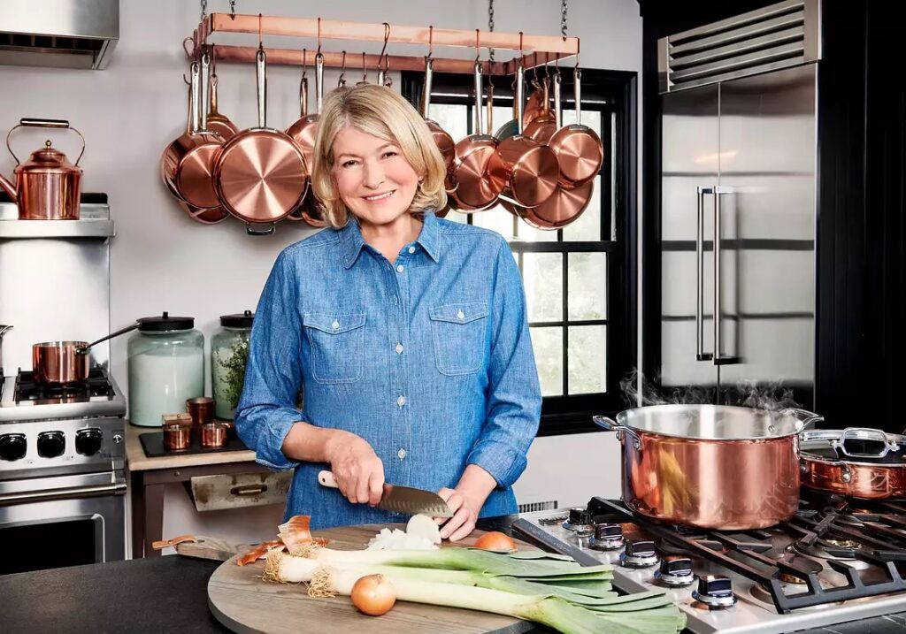 Martha Stewart in her kitchen slicing leeks.