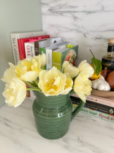 Pitcher of tulips on kitchen counter.
