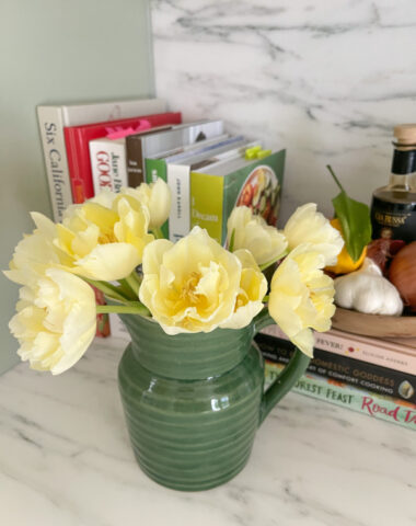 Pitcher of tulips on kitchen counter.