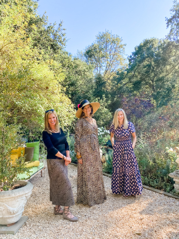 Three women wearing dressing in a garden.