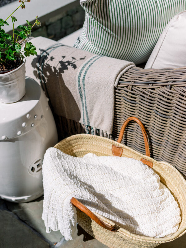 Basket of throws on patio.