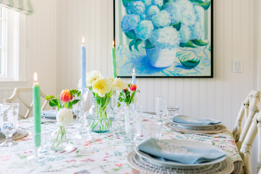 Spring table setting with hydrangea painting on wall.