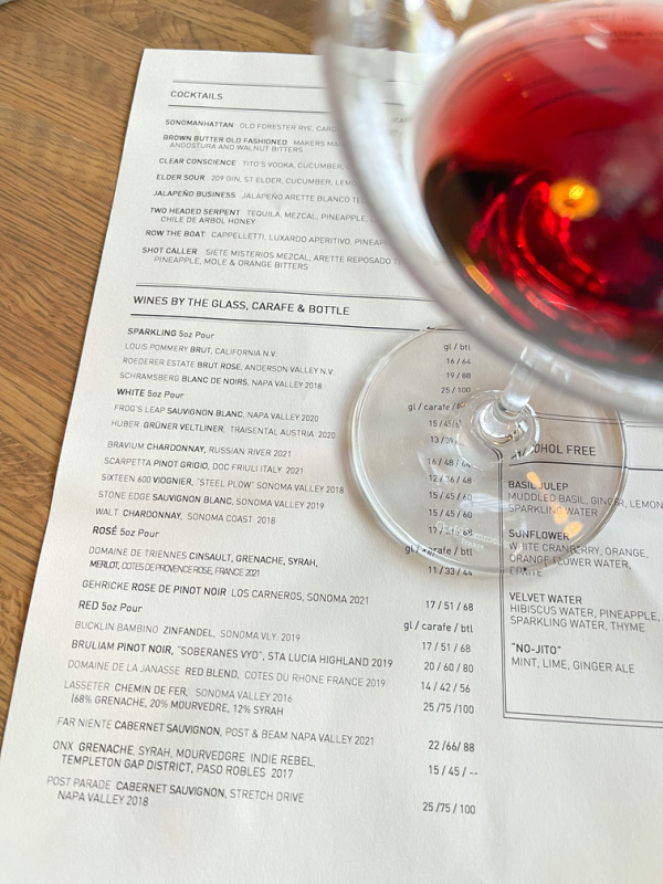 El Dorado Kitchen menu and glass of red wine.