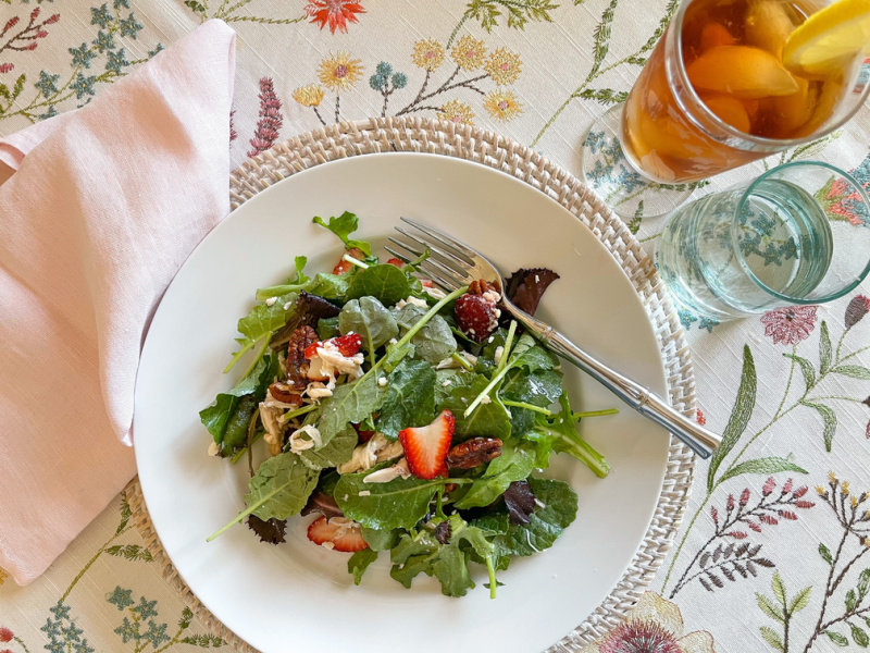 Luncheon salad on pretty floral table cloth.