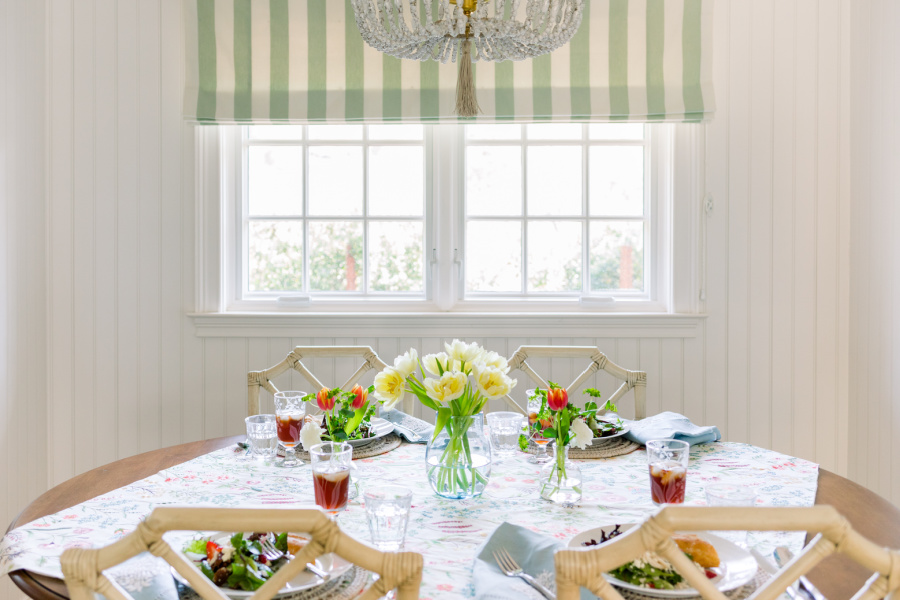 Srping table setting for four with plated spring salads and iced tea with florals down the center.