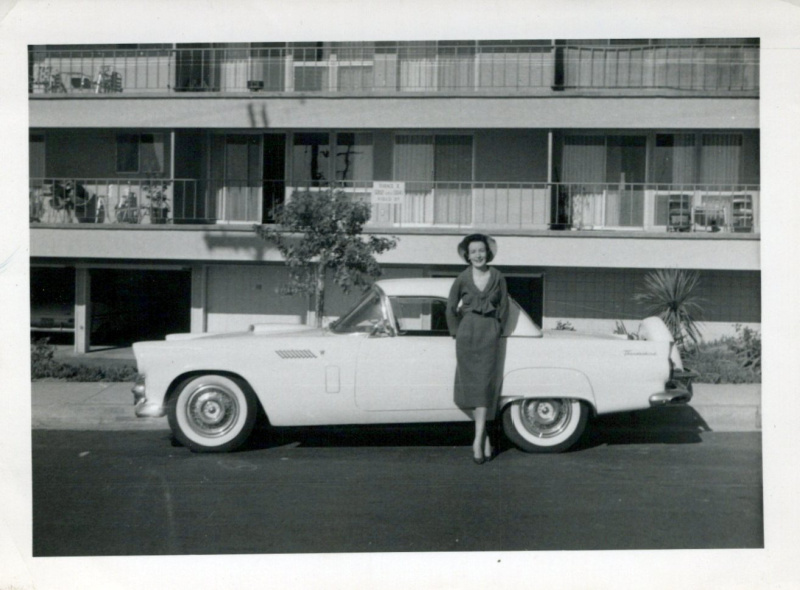 Woman standing in front of 1950s Thunderbird.