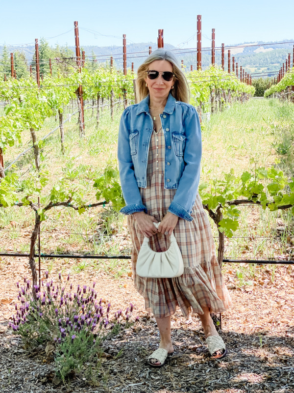 Woman standing in grape vineyard in St. Helena.