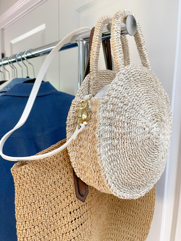 Two woven bags hanging on rolling rack ready to pack for NAPA VALLEY.