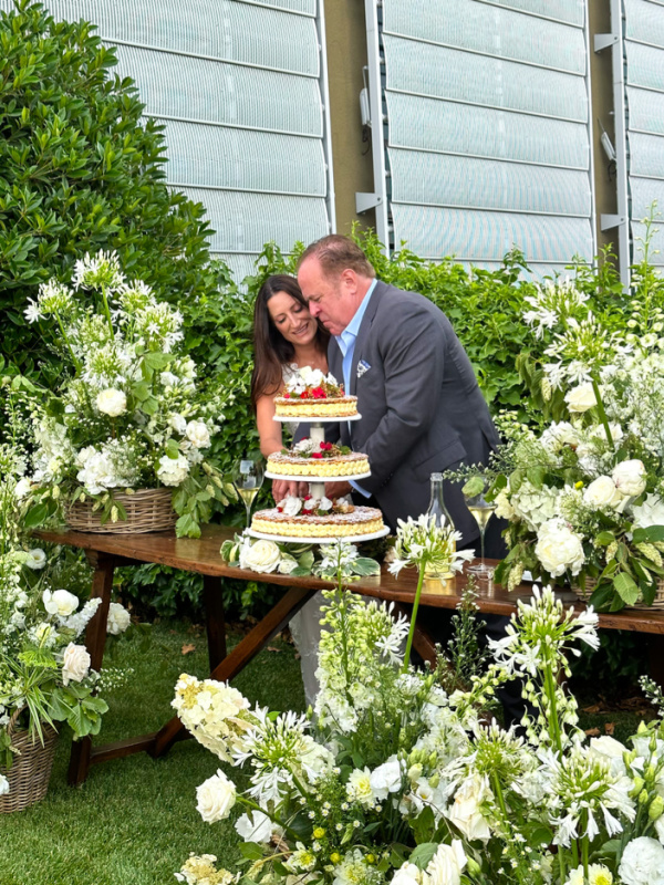 Couple cutting wedding cake at Ca' Del Bosco winery in Italy.