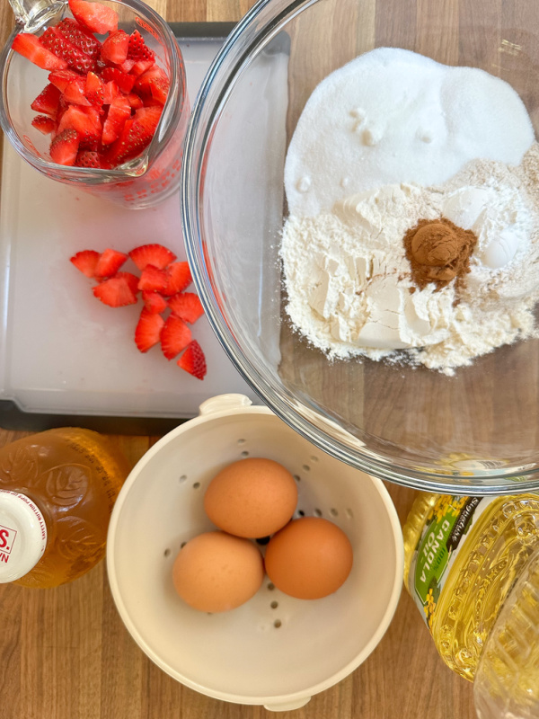 Ingredients laid out to make strawberry muffins.