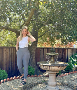 Woman in garden wearing gray joggers from Old Navy.