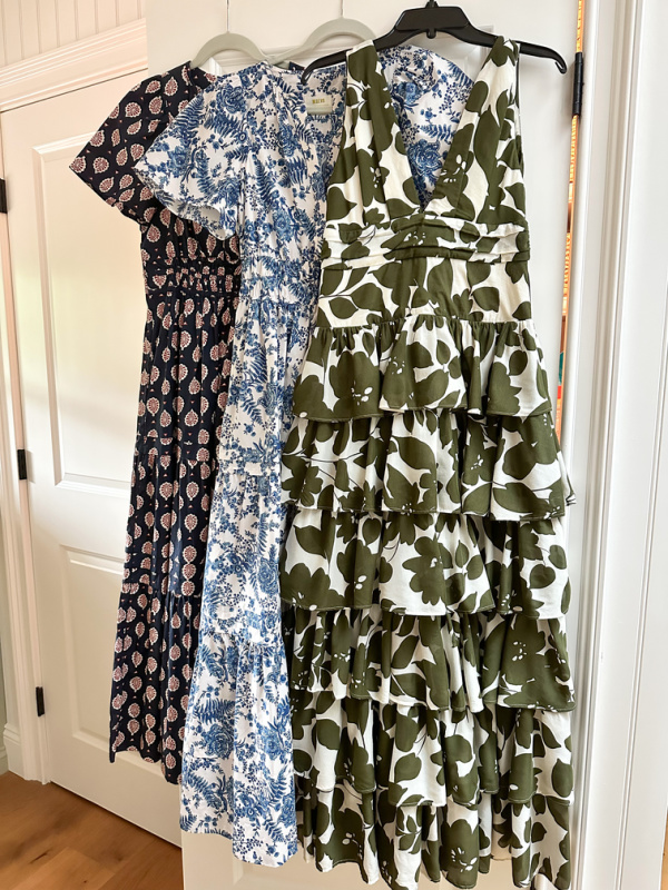 Three maxi dresses hanging on closet door.